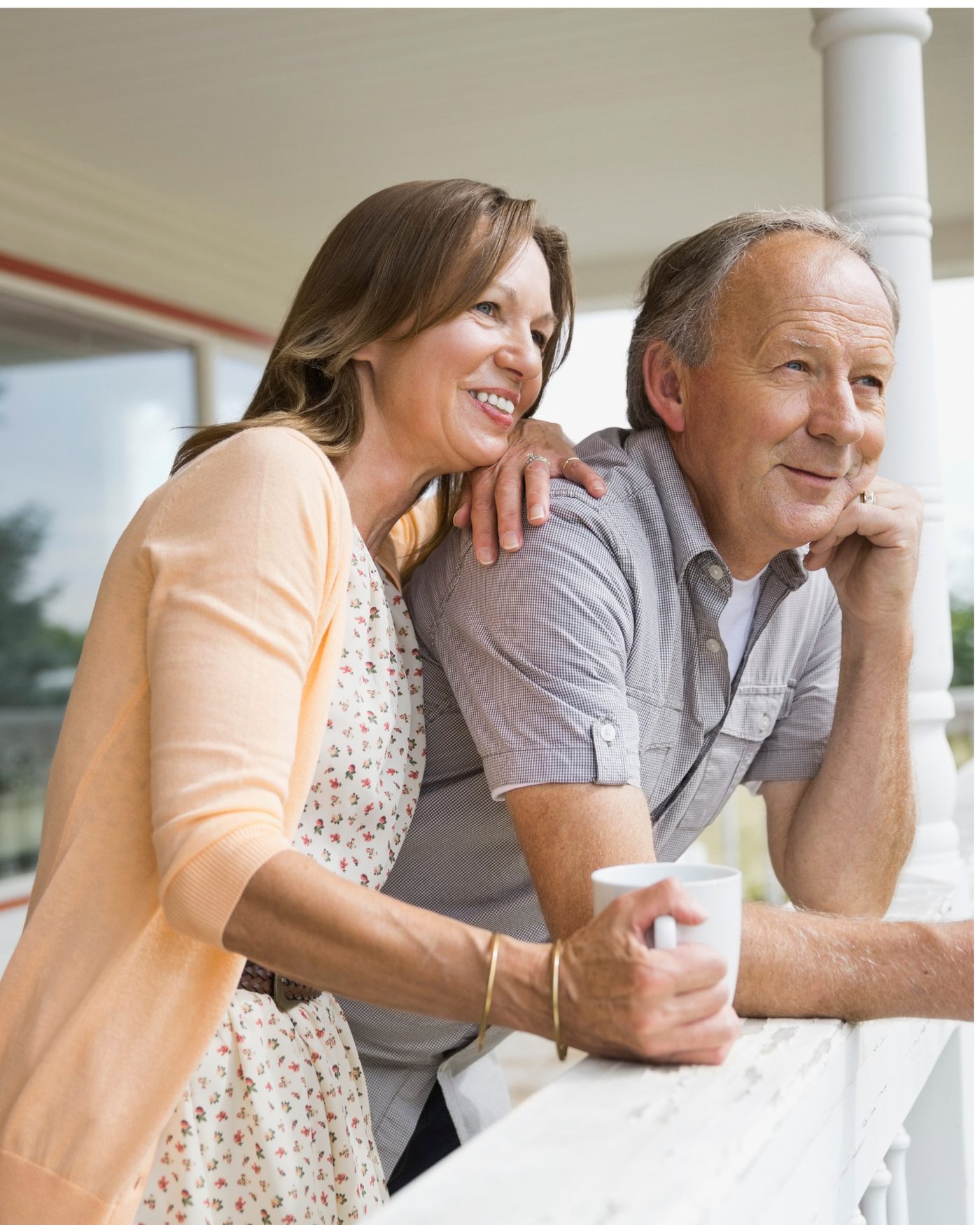 A couple in their late fifties enjoying an unhurried morning on their porch