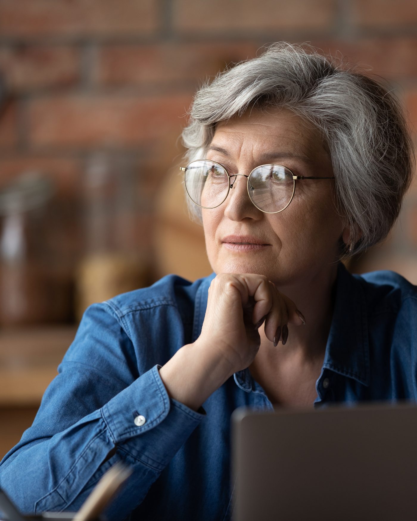 A woman in her sixties at home in a quiet, thoughtful moment